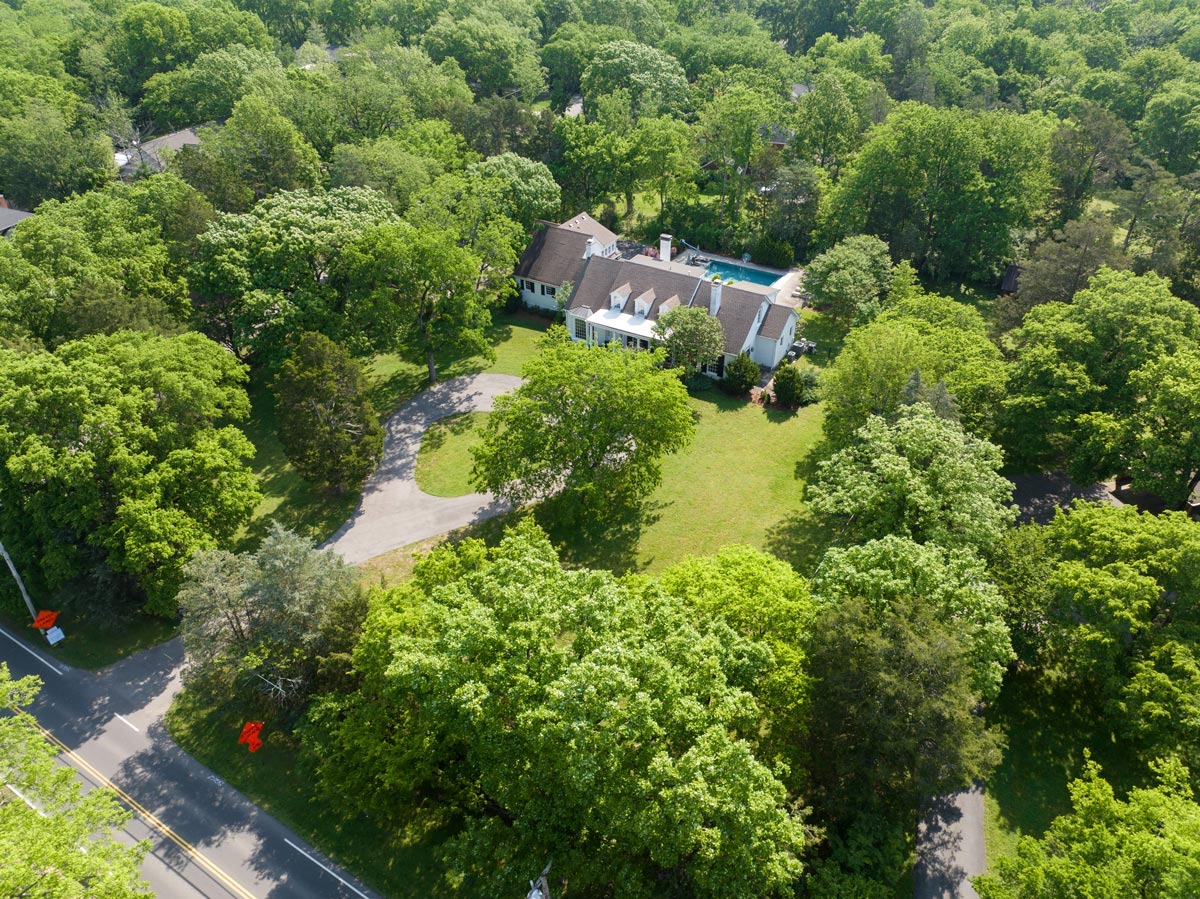 Aerial view of a wooded Nashville, TN property with a private pool